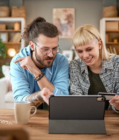 Hipster couple looking at ipad