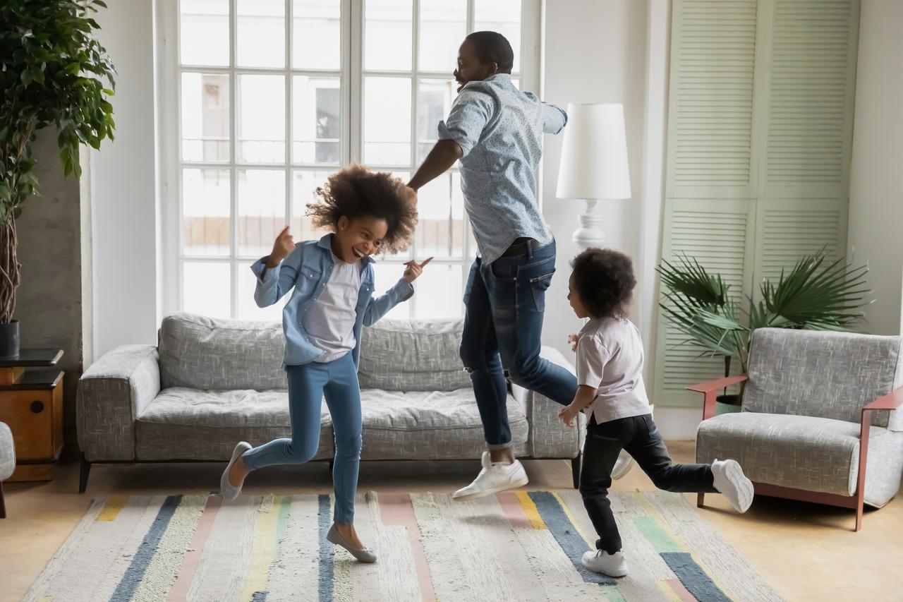 Father dancing with two daughters