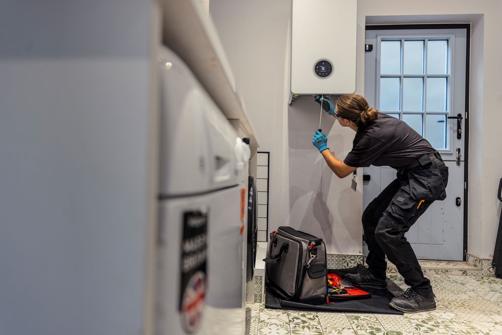 Boiler engineer fixing boiler