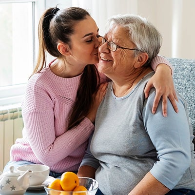 Woman kissing her grandmother