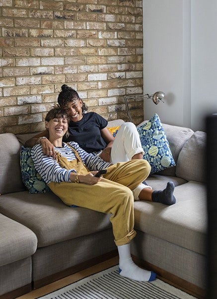 Couple on sofa watching TV