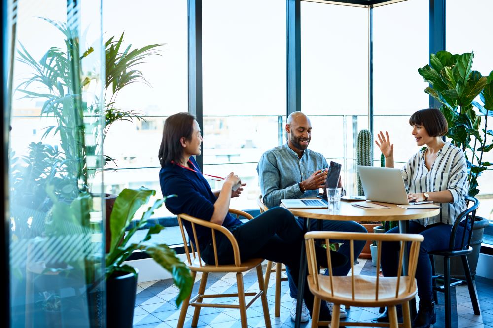 Three relaxed business colleagues meeting in cafe
