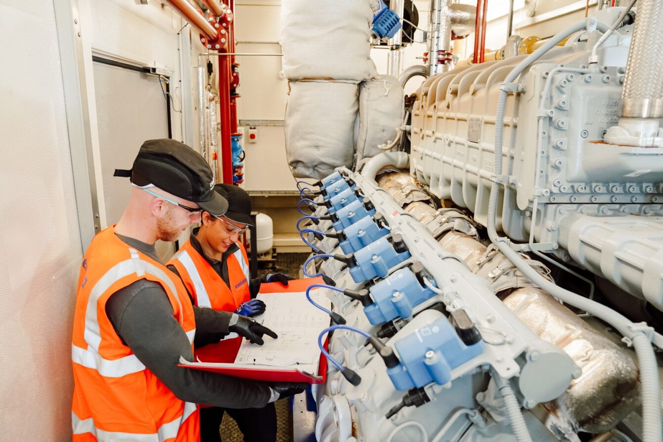 Engineers inspecting a combined heat and power system