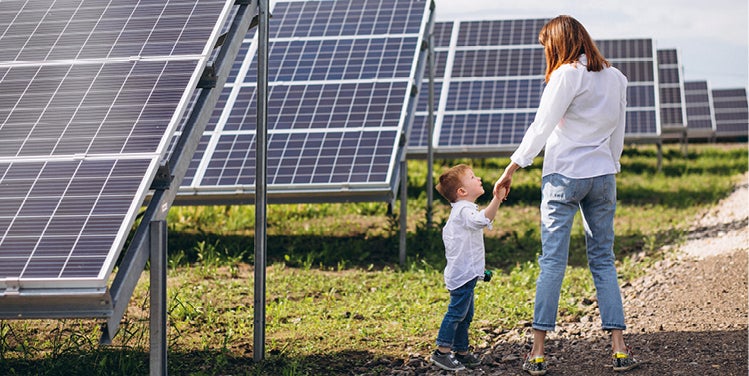 Woman and child by solar panels