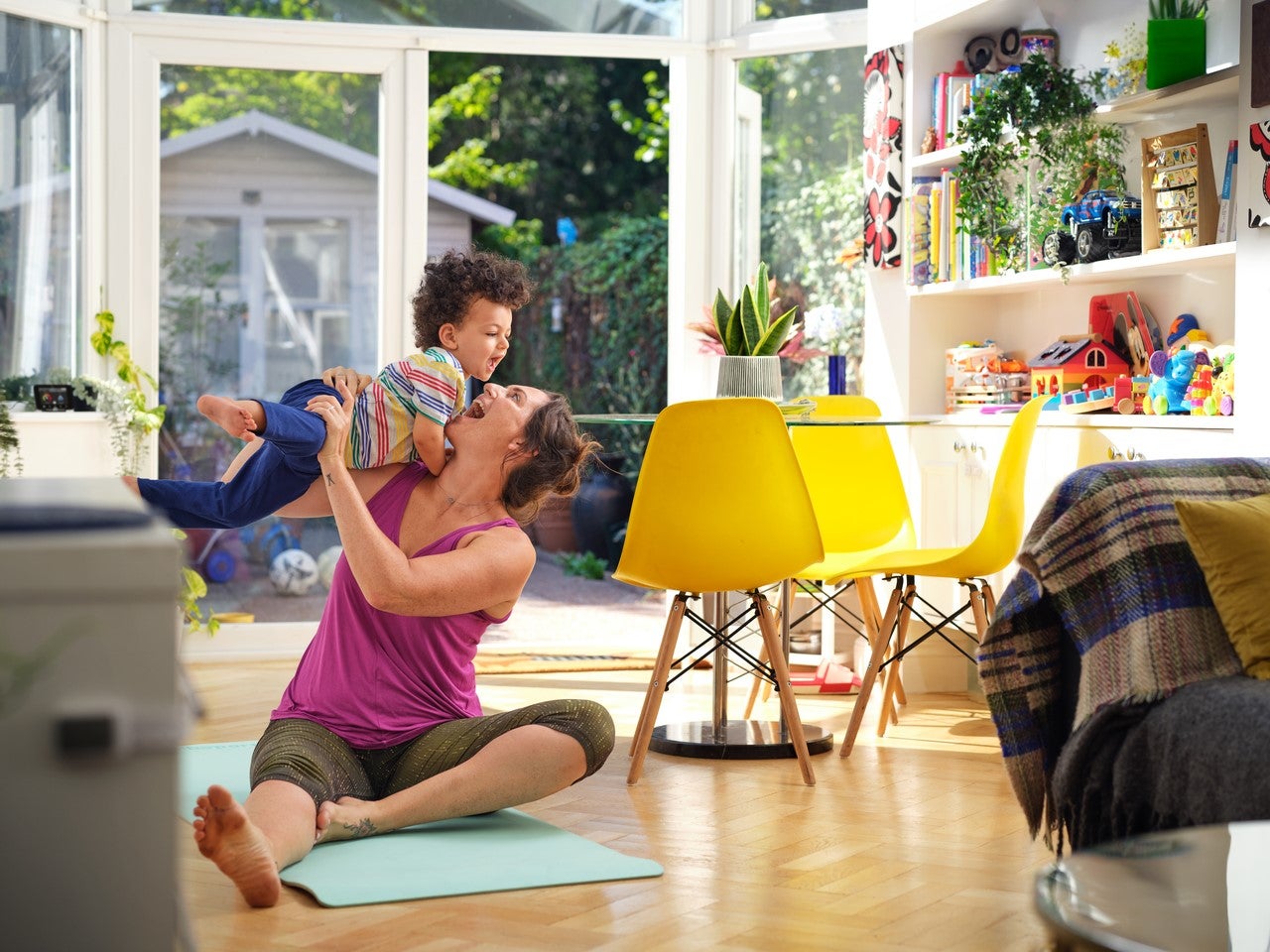 Woman doing yoga with child