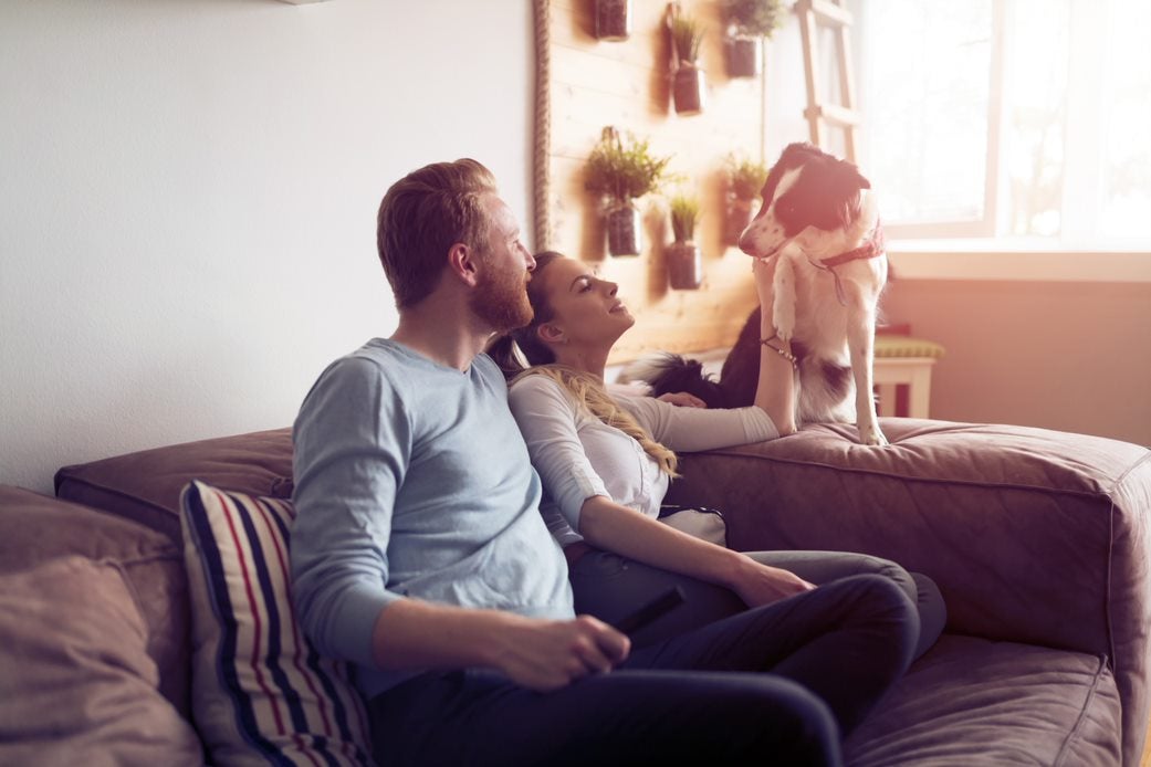 Couple on couch with dog