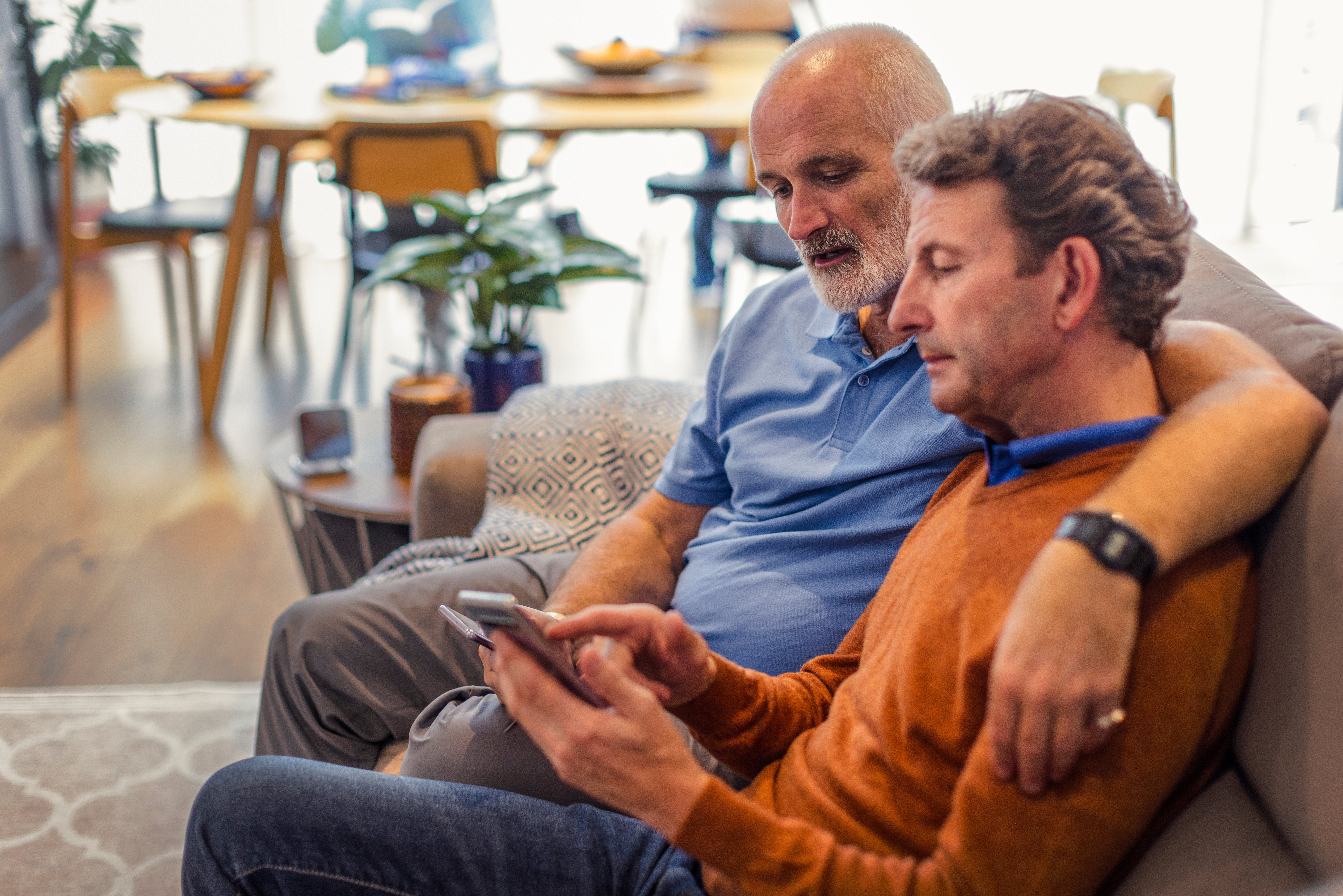 Mature same sex couple browsing on their phone