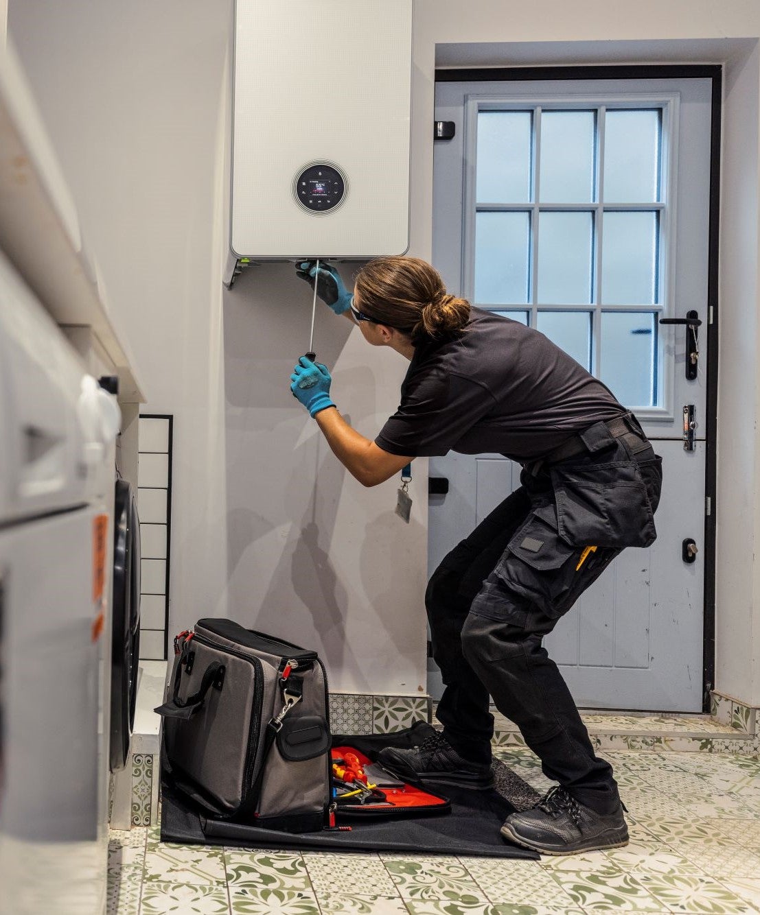 Woman fixing boiler