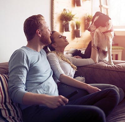 Couple on couch with dog