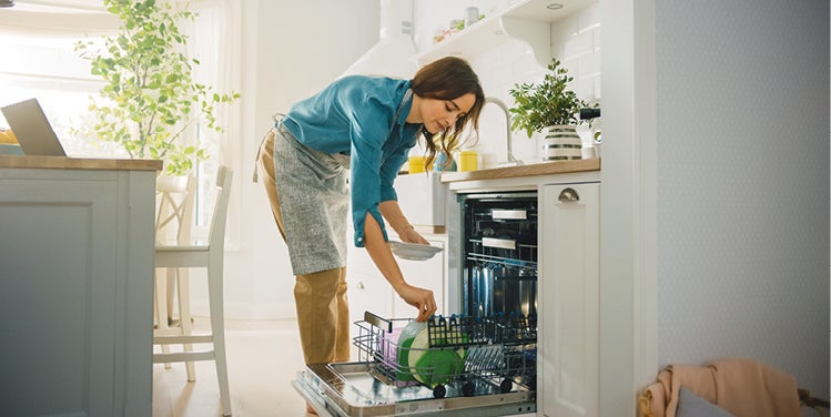 Woman loading dishwasher