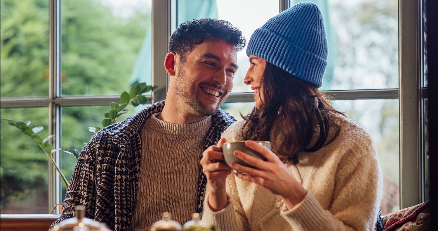 Woman and man sharing a laugh over coffee