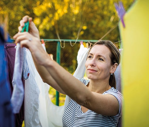 Woman hanging clothes on washing line
