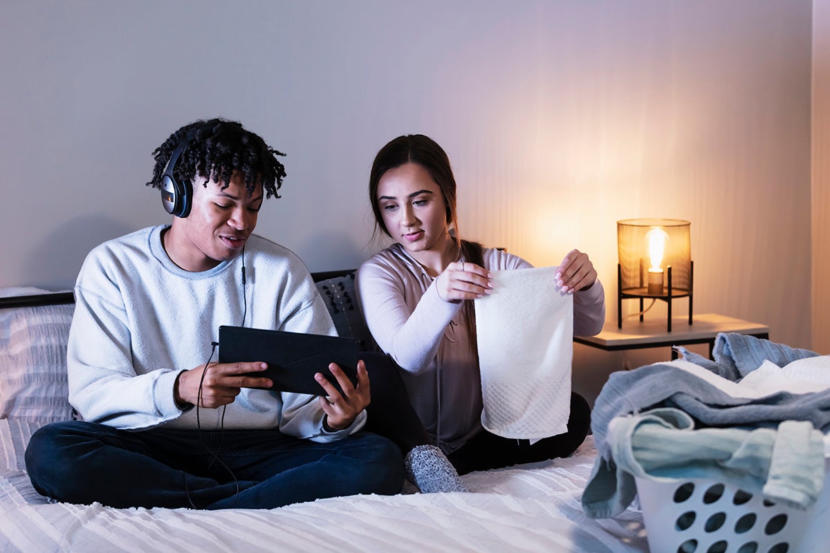 Couple in bed looking at tablet