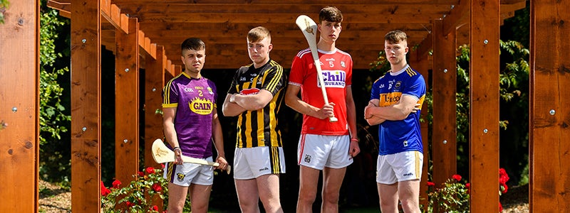 4 hurling players standing