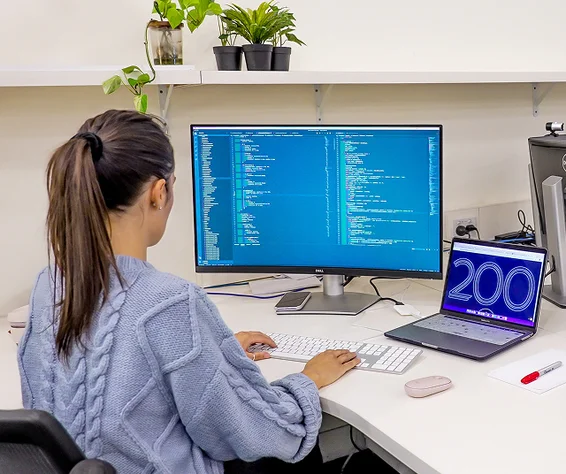 women looking at her code on computer