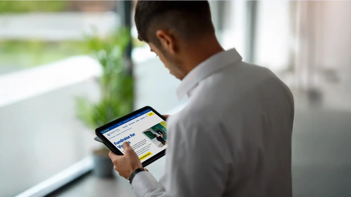 Man looking at Vinnies website on a tablet