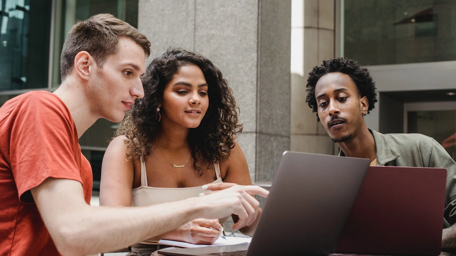 Students working together looking over a computer
