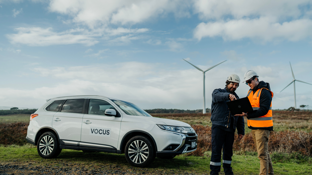 Vocus workers in front of windmill