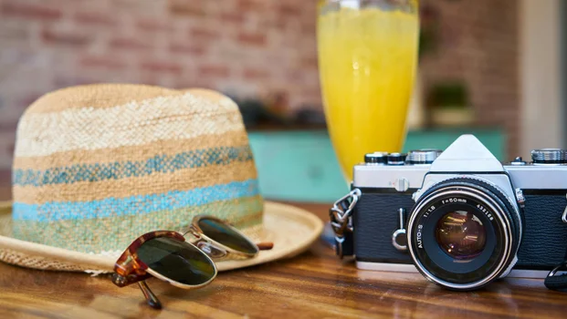 Camera, hat and cocktail.