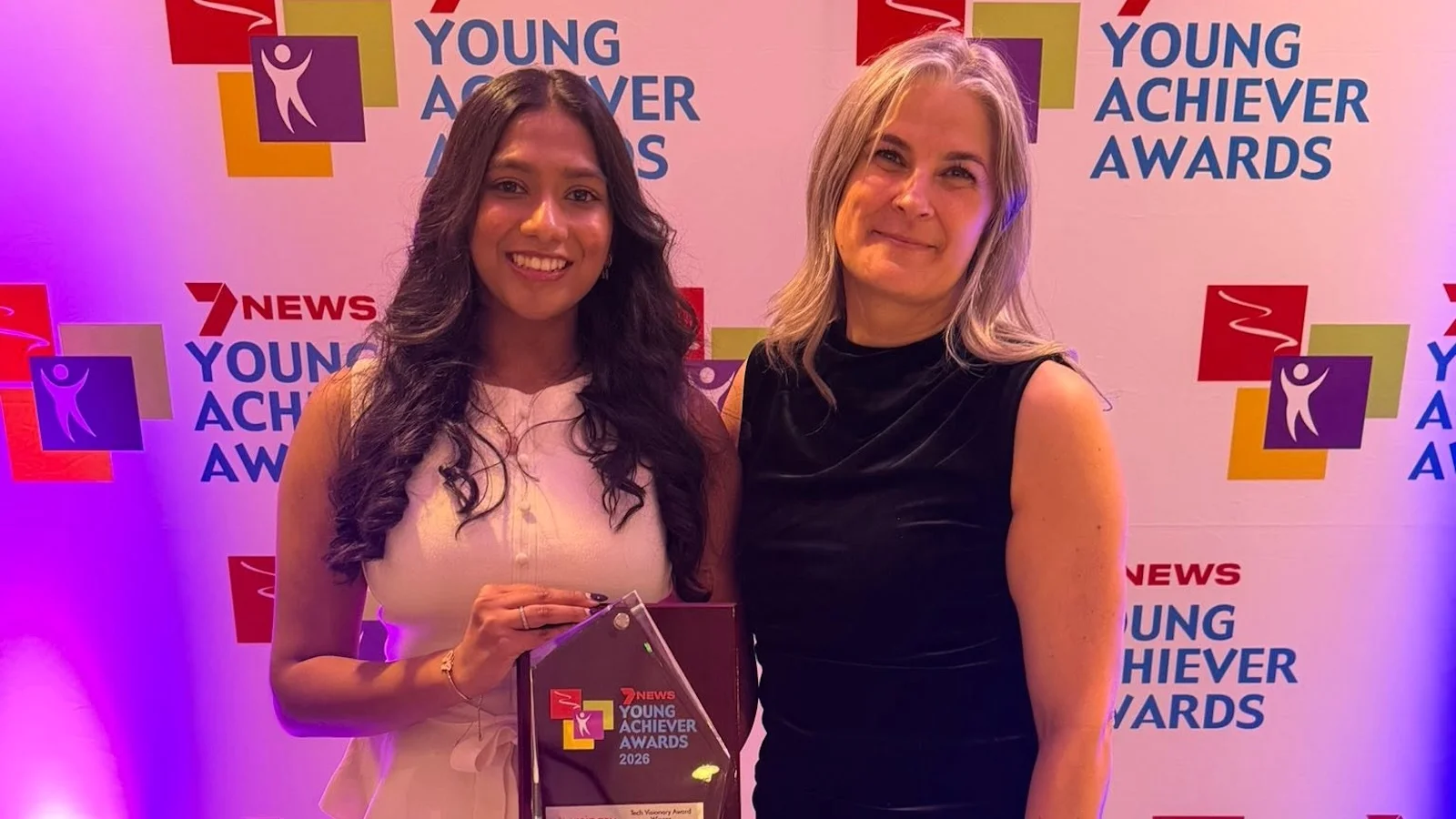 Sarah presenting to Kaushal's sister at YAA 2026
