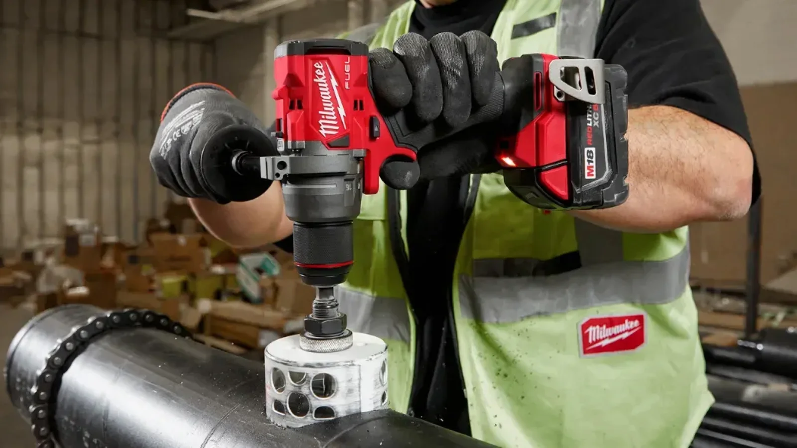 Picture of a man using a Ryobi power tool in a shed