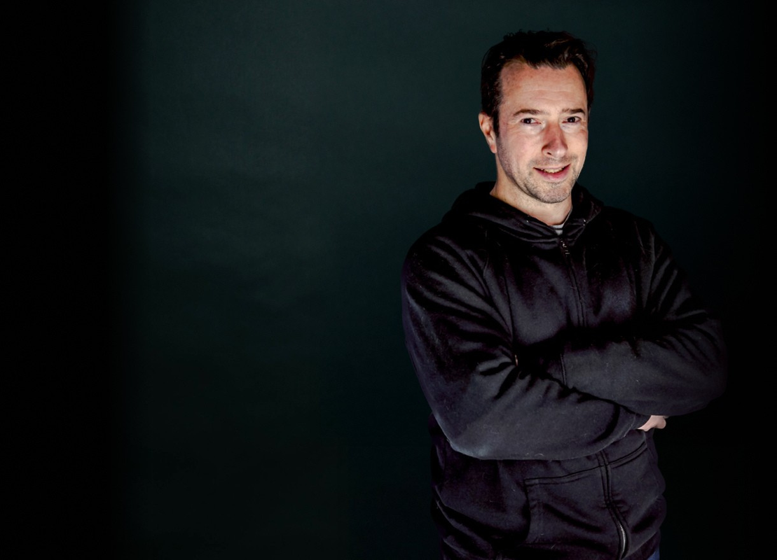 Picture of Dammian against a black screen