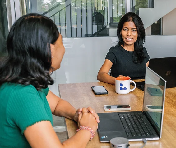 women discussiong and smilling