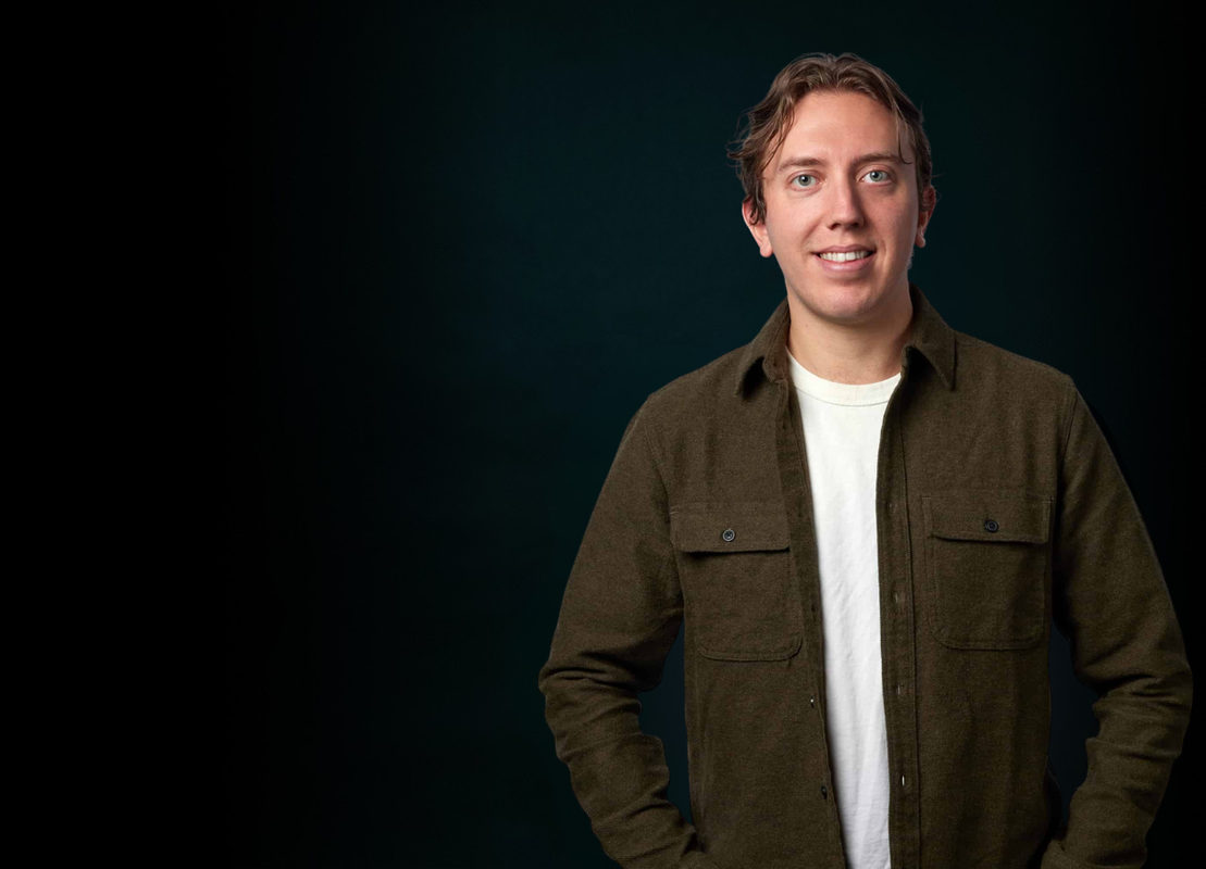 Picture of Lewis standing against a black background