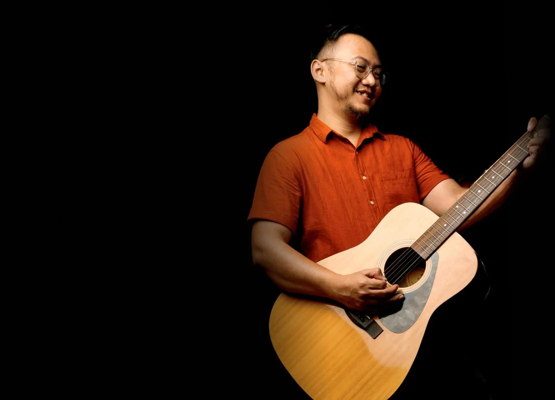 Picture of Erian playing a guitar