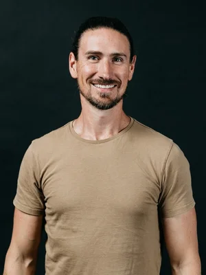 Picture of Luminary CTO Andy smiling with a black background