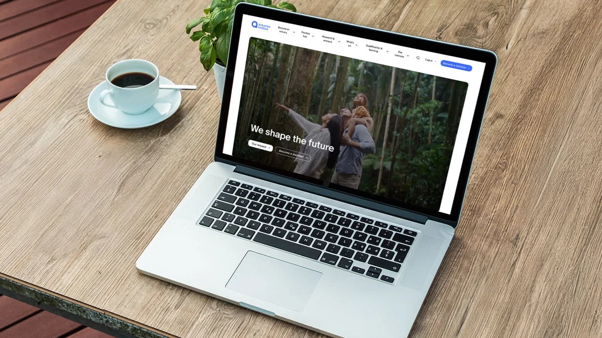 Picture of a laptop open with an Actuaries website on the screen