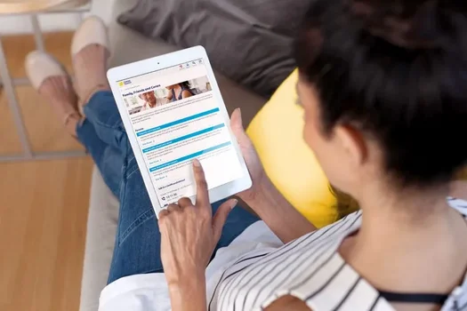 A woman using the Cancer Council Australia website on a tablet