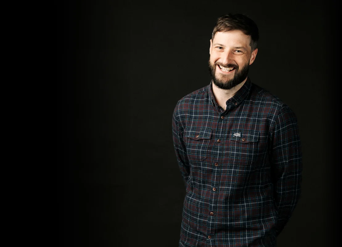 Picture of Ashley Pickering standing against a black background