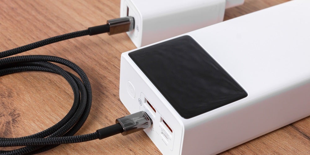 A white device is charging by USB-PD battery charger