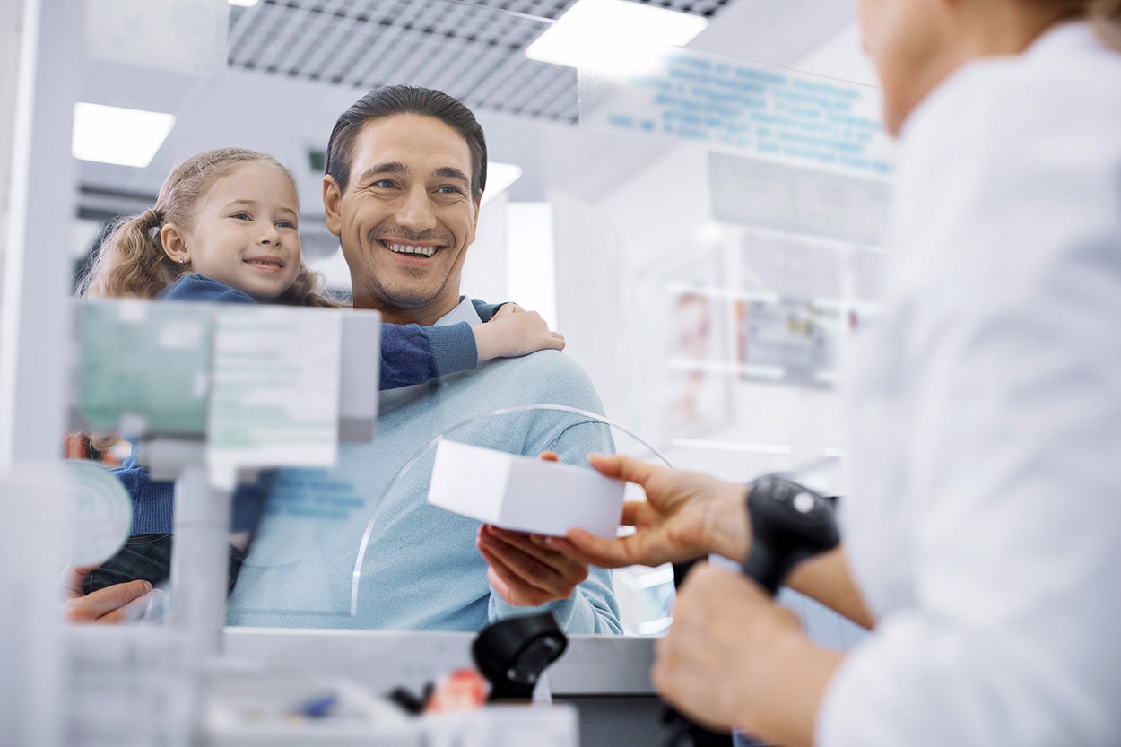 a man in a pharmacy with his daughter