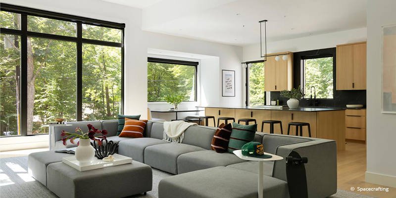 Large forgent windows let in brilliant amounts of light in living room and kitchen