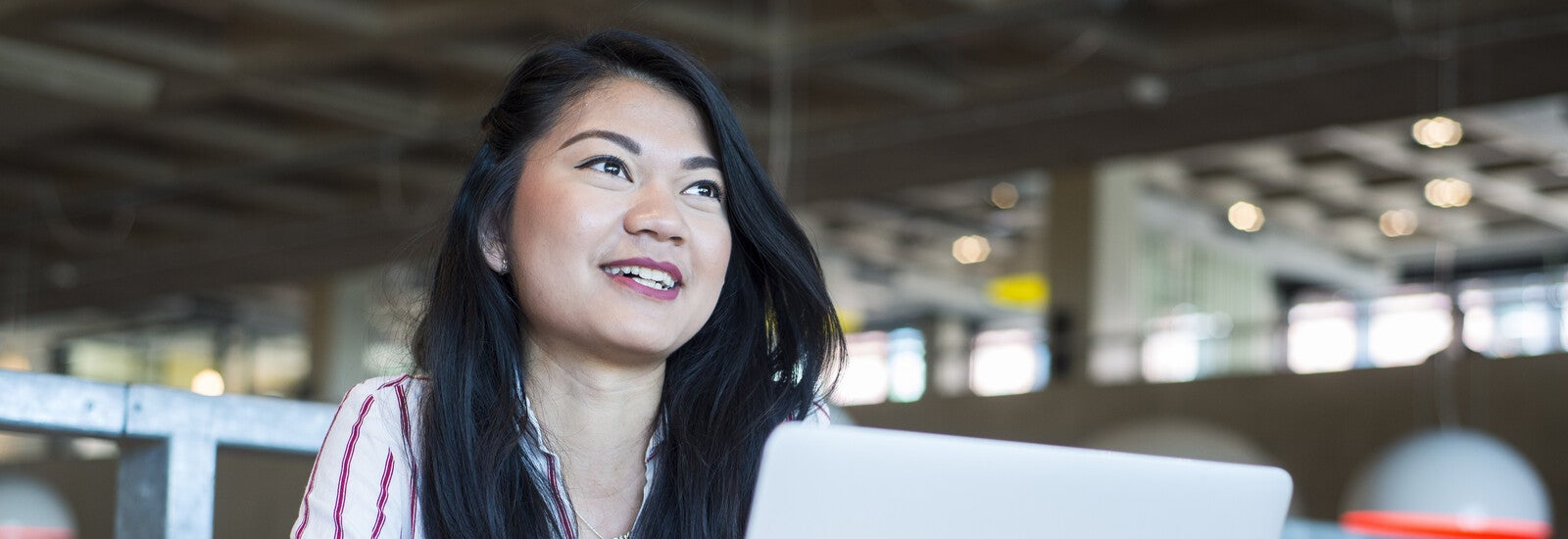An international student working on her laptop