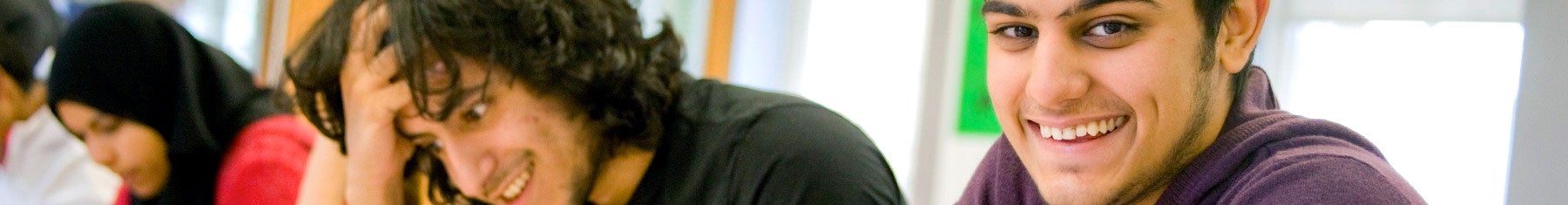 Student smiling at camera in class