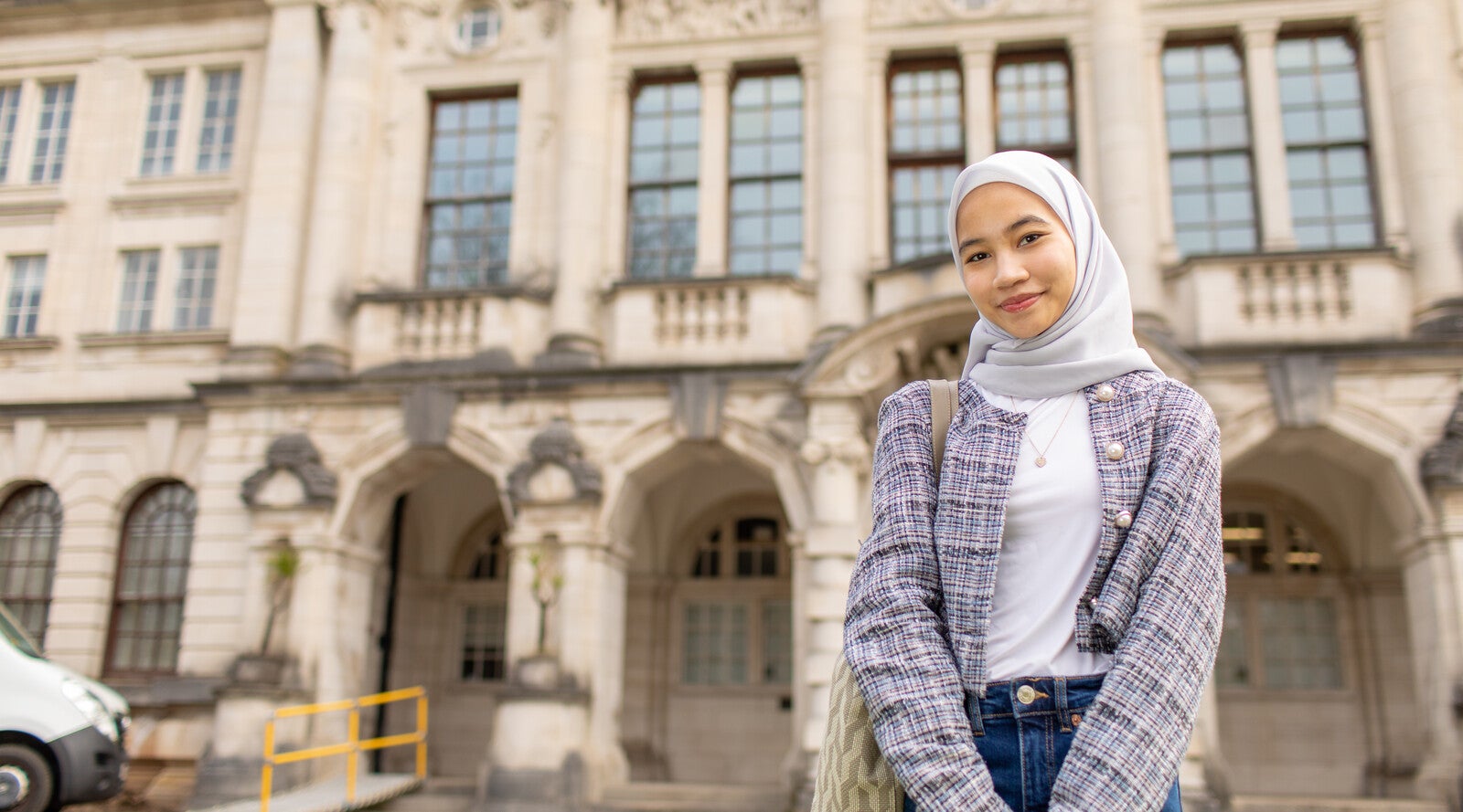 Student smiling outside campus