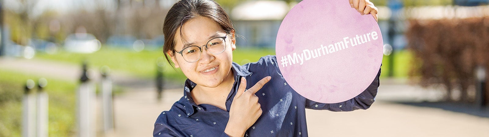 Student pointing to sign