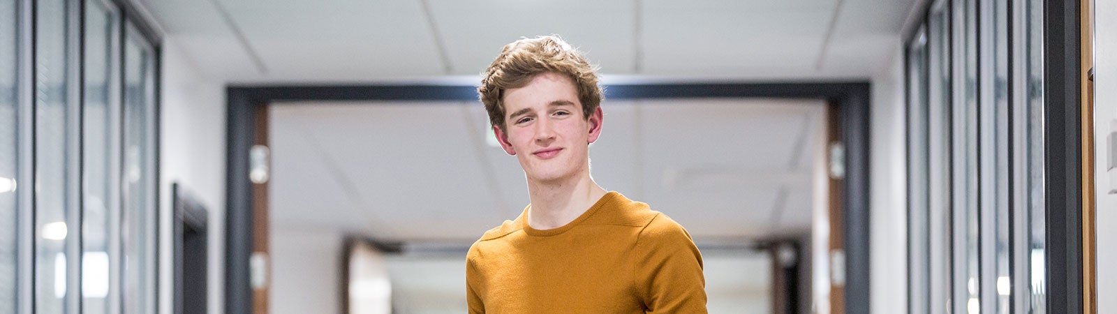 Student smiling at camera on campus
