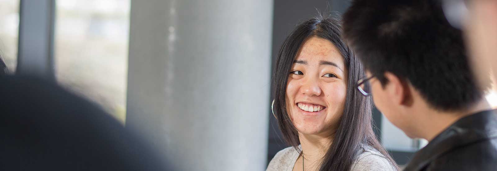 A smiling student in a classroom