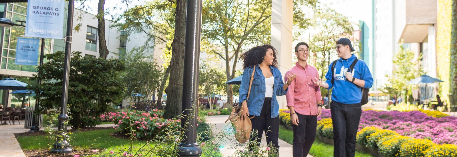 Three students walking together outside campus