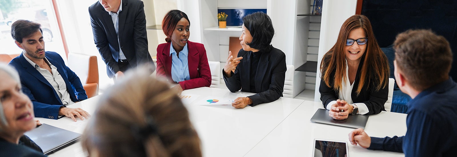 Employees sitting around a table chatting.