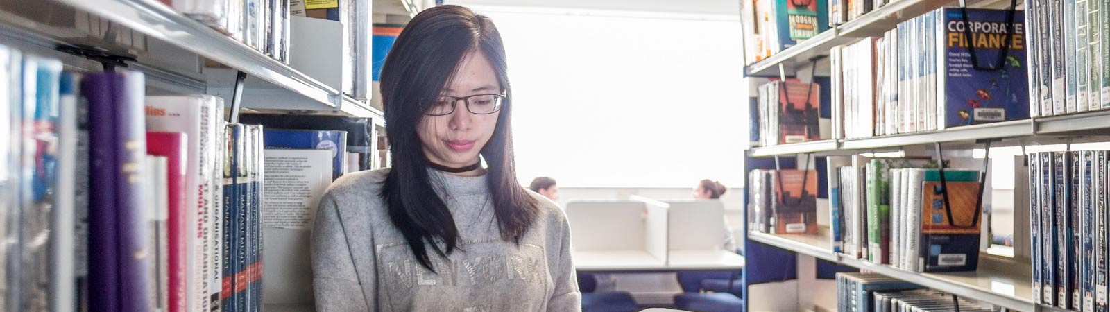 Student reading in library