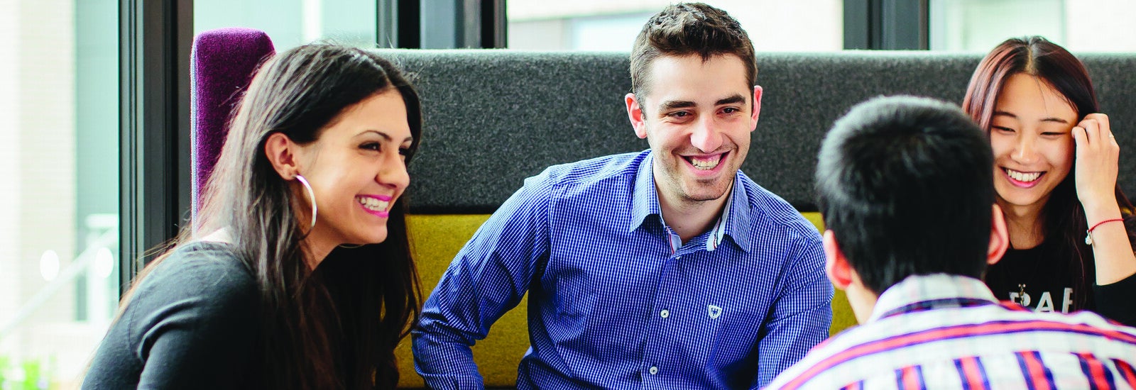 Student on campus smiling at camera