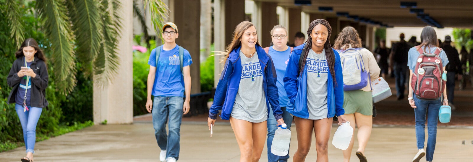 Students walking together wearing track uniforms