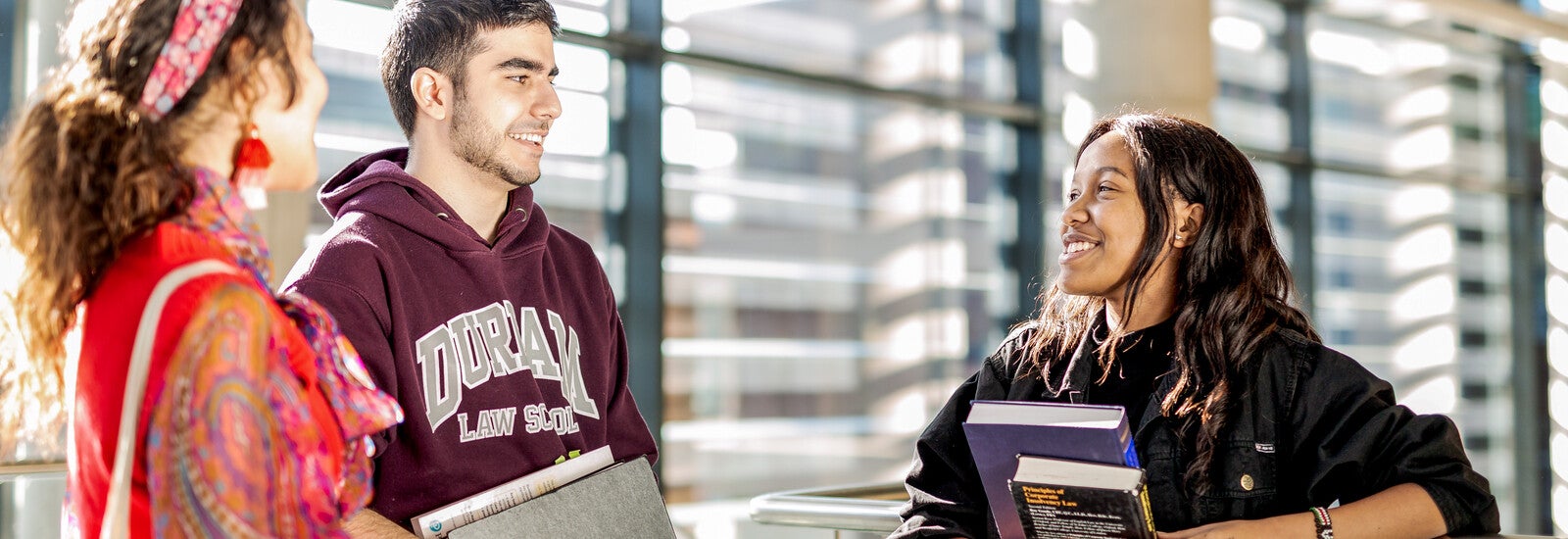 Three Durham students talking on campus