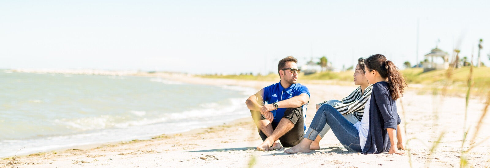 Students sitting on beach together