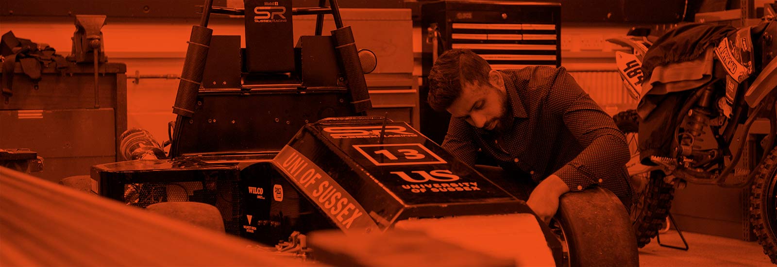 A University of Sussex student working on a race car